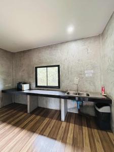 a kitchen with a sink and a window on the wall at Share pool 1 room 2 bedroom in Ao Nang 