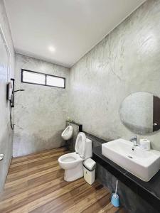 a bathroom with a toilet and a sink and a mirror at Share pool 1 room 2 bedroom in Ao Nang 