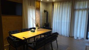 a conference room with a wooden table and chairs at Спас Резорт in Spas