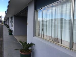 a window with a view of a building at The Commercial Hotel Motel in Chinchilla