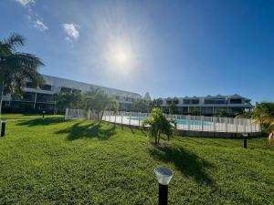 a yard with a fence and a swimming pool at Infinity View Beach House, 2 bdr in Baie Nettle