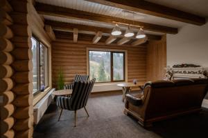 a living room with a couch and a table at LAVANDA hotel club in Slavske