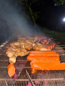 a grill with meat and vegetables on it at Leopardbay Cabanas Arugambay in Arugam Bay