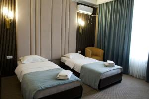 Postel nebo postele na pokoji v ubytování Гостиница SHAHRISTAN