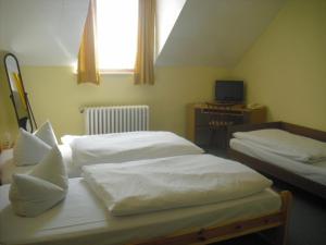 Postel nebo postele na pokoji v ubytování Hotel Feilen-Wolff