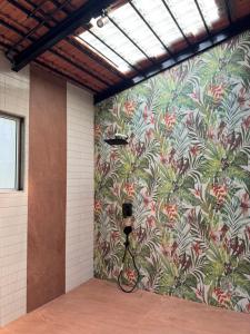 a wall with a mural with a camera on it at NOSSA GOA VILLA in MUMBAI GORAI in Mumbai