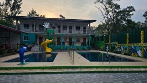 a house with a swimming pool and a playground at Alpas mountain pool resort in Santa Monica