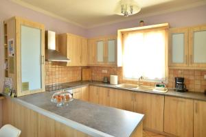 a kitchen with wooden cabinets and a counter top at Tzitzi Pistachio Villa in Khlóï +33 photos
