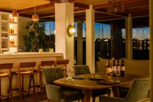 a restaurant with a table and chairs with wine glasses at Safrani Suites in Santorini