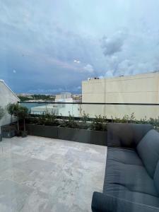a couch sitting on the roof of a building at Torri Studios in Sliema