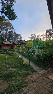 a garden with a fence and some plants and houses at Alpas mountain pool resort in Santa Monica