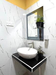 a bathroom with a sink and a mirror at Chaya Villa Guest House in Beruwala +60 photos