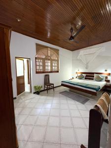a bedroom with a bed and a wooden ceiling at Chaya Villa Guest House in Beruwala