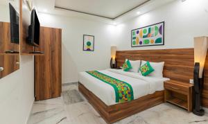 a bedroom with a bed and a television in a room at Treebo Buddha Pride in Patna