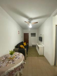 a living room with a couch and a table at Ao lado do Hospital Calixto apartamento térreo in Itabuna