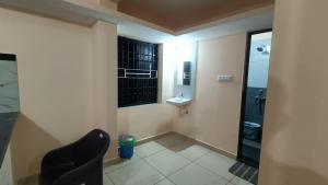 a small bathroom with a sink and a toilet at Gokula Arcade in Subrahmanya +23 photos