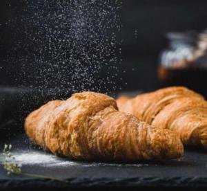 two croissants are being fried on a table at Jovan Suites apartment 2 in AlUla