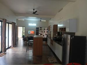 a kitchen and dining room with a table and chairs at Mini Meadow in Neyyāttinkara