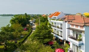 arial view of a city with a river and buildings at Gia Huy Riverside Hotel Hoi An in Hoi An