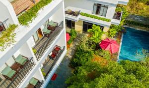 an aerial view of a building with a swimming pool at Gia Huy Riverside Hotel Hoi An in Hoi An