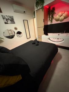 a room with a black table and a tv at La Sensuelle Parenthèse in Sète