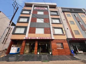 a tall building with a hotel front inn at The Hotel Phoenix Inn in Indore