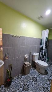 a bathroom with a toilet and a sink at Alpas mountain pool resort in Santa Monica +10 photos