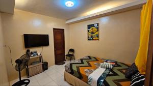 a bedroom with a bed and a flat screen tv at Alpas mountain pool resort in Santa Monica