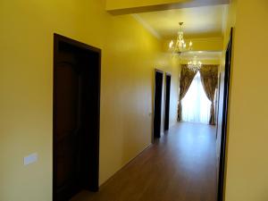 an empty room with a chandelier and a hallway at Sunrise Hotel in Adjud +2 photos