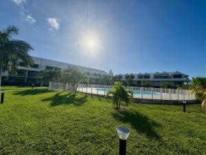 a yard with a fence and a swimming pool at Always Sun ,1 bdr up to 4 guests in Baie Nettle