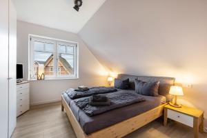 Ένα ή περισσότερα κρεβάτια σε δωμάτιο στο Ferienhaus Treibholz