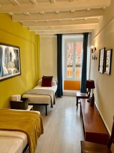 a room with two beds and a window at Charming Navona in Rome