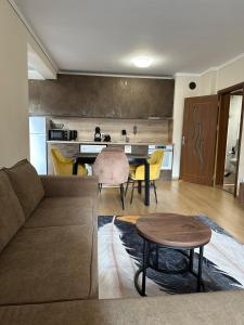 a living room with a couch and a table at Alex Suite in Veliko Tŭrnovo