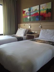 a hotel room with two beds and a window at Crystal Suites in Amman +57 photos