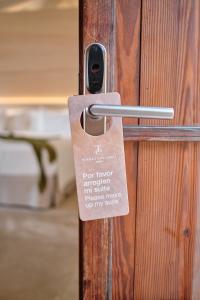 a wooden door with a key tag on it at Can Simoneta - Adults Only in Canyamel