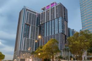 two tall skyscrapers in a city at dusk at The Platinum Kuala Lumpur by MAHA in Kuala Lumpur