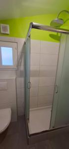 a shower with a glass door in a bathroom at Le Vallon du Garn - Gîte en pleine nature in Laval-Saint-Roman