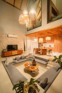 a living room with a couch and a table at Pai Prestige - Luxury Pool Villas in the centre of Pai in Pai
