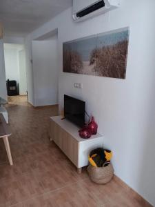 a living room with a flat screen tv on a table at casa andaluza 109 in Novo Sancti Petri