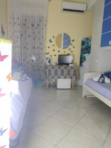 a living room with a couch and a table at Butterfly Room in Scordia