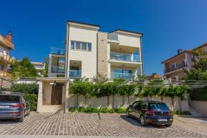 two cars parked in front of a house at Apartment in Crikvenica 41679 in Crikvenica