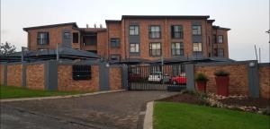 a building with a black gate and a building at Peaceful Casa in Kempton Park