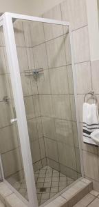 a shower with a glass door in a bathroom at Peaceful Casa in Kempton Park