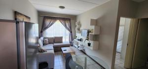 a living room with a couch and a window at Peaceful Casa in Kempton Park