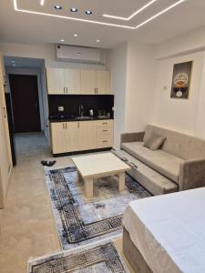 a living room with a couch and a coffee table at Bay View Sahl Hasheesh Chalet in Hurghada