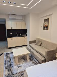 a living room with a couch and a table at Bay View Sahl Hasheesh Chalet in Hurghada