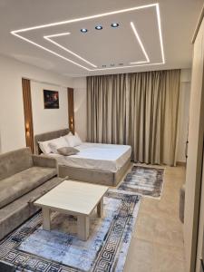 a living room with a bed and a couch at Bay View Sahl Hasheesh Chalet in Hurghada