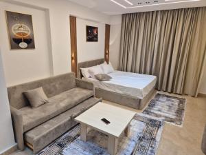 a living room with a couch and a bed at Bay View Sahl Hasheesh Chalet in Hurghada