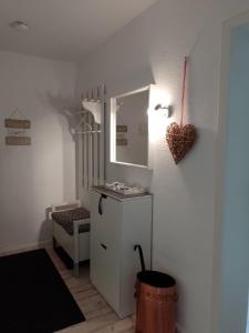 a room with a small white cabinet and a mirror at Ferienwohnung Jesper in Braunlage