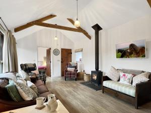 a living room with a couch and a fireplace at Westlands Brendon Hill in Treborough